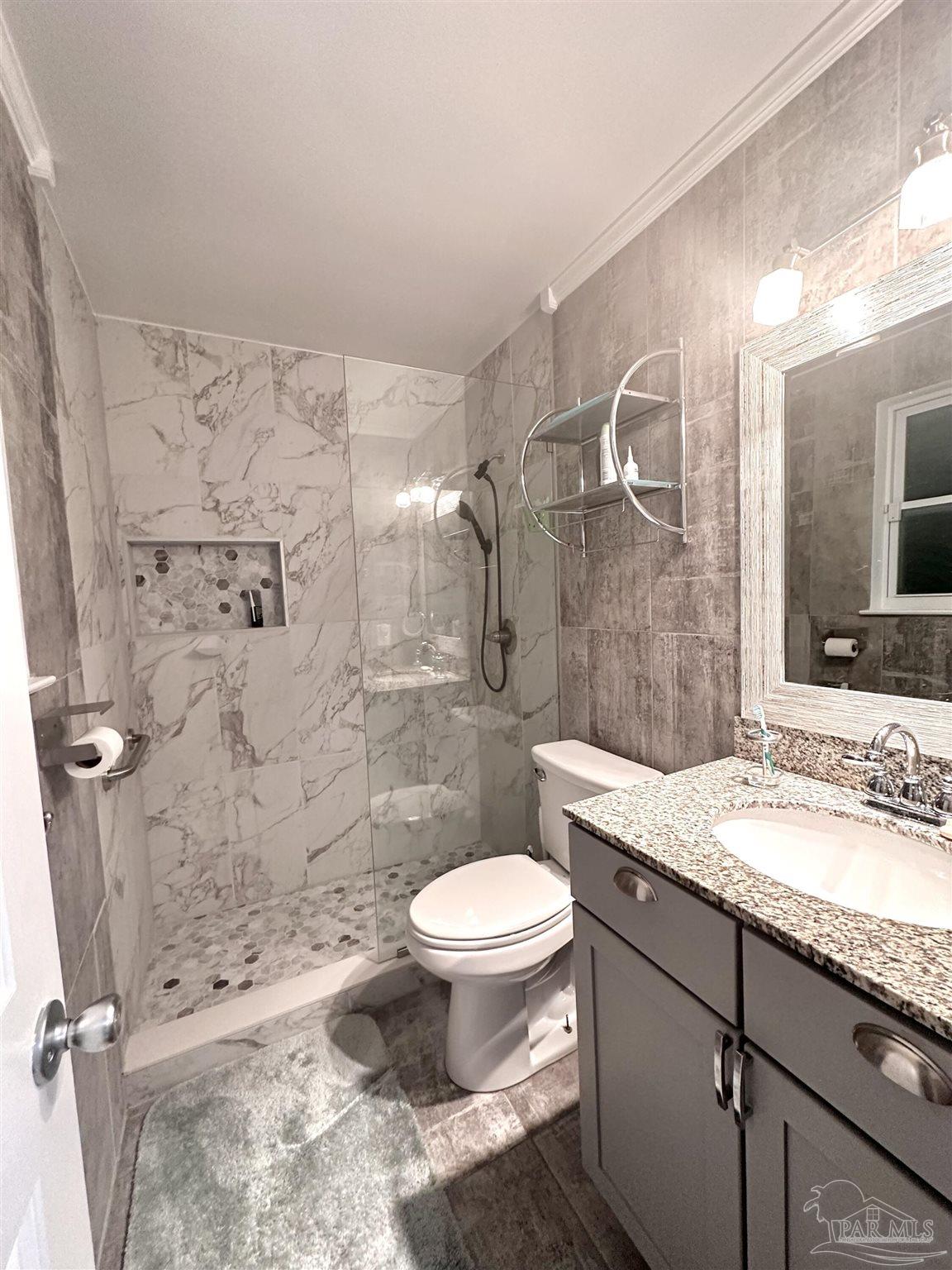 3097 Fayal Drive Pensacola, FL 32526 - Photo 27 of 46 a bathroom with a granite countertop sink toilet mirror and shower