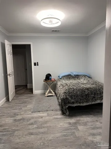 a bedroom with a bed and a chair