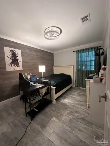 a bedroom with a bed dresser and a window