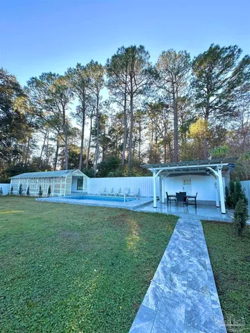 a view of a backyard with a tub and trees