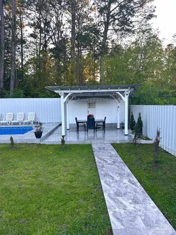 a view of a dining table and chairs in the patio