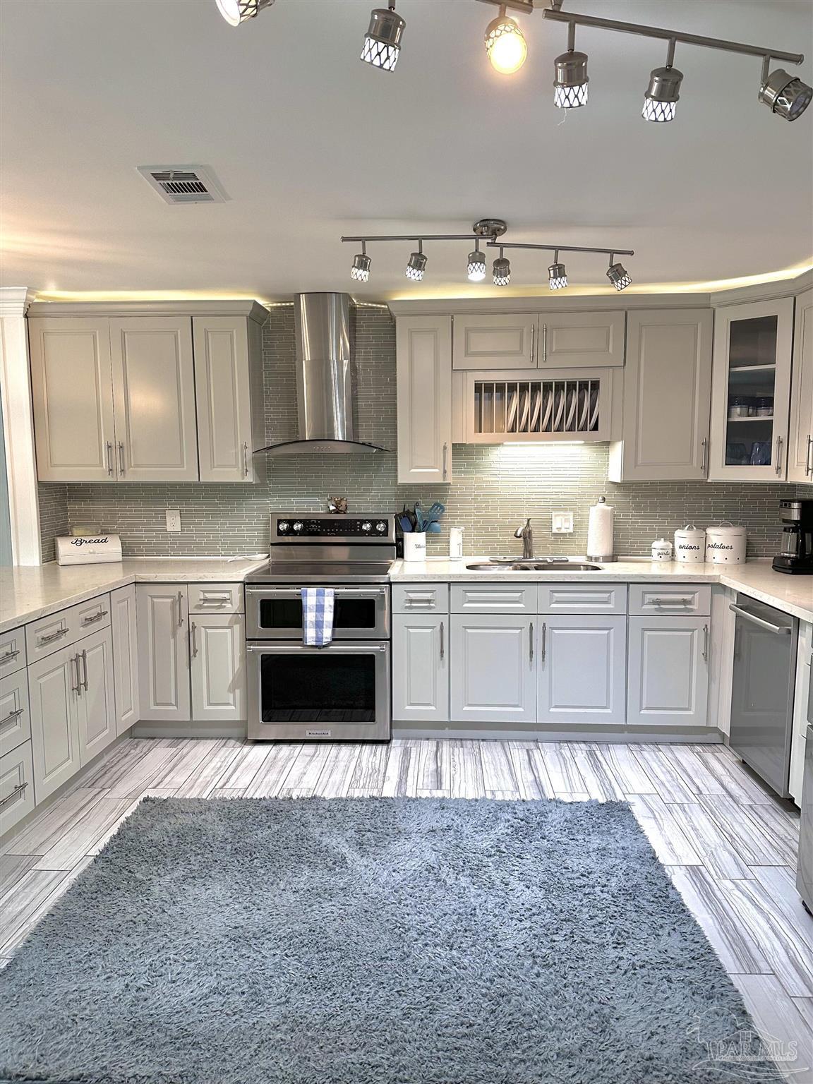 3097 Fayal Drive Pensacola, FL 32526 - Photo 6 of 46 a kitchen with a stove top oven sink and cabinets