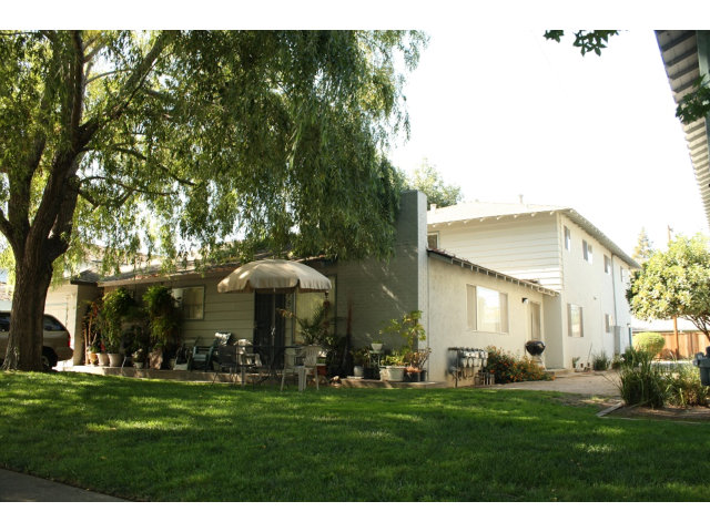 a front view of a house with a garden