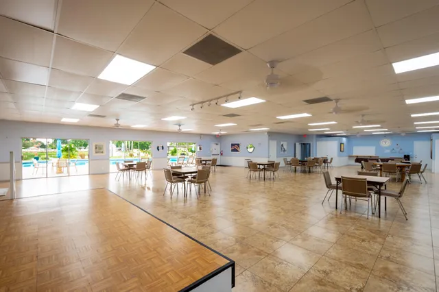 a dining room with lots of furniture and view kitchen