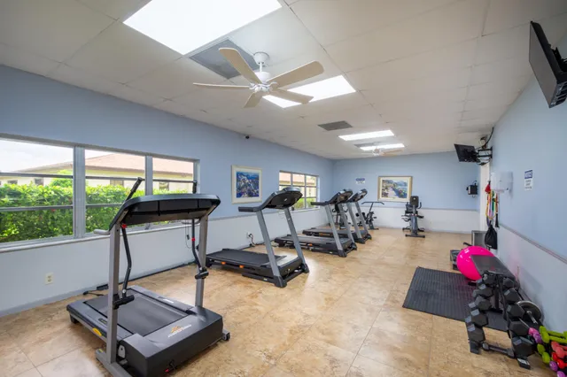a room with gym equipment and a large window