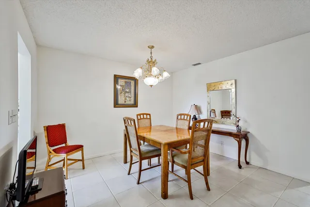 a dining room with furniture and chandelier