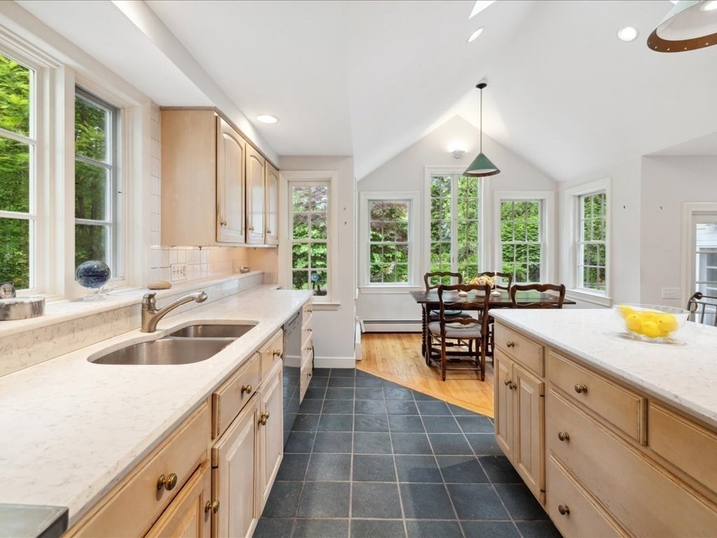 234 Lowell Road Wellesley, MA 02481 - Photo 9 of 30 a large kitchen with kitchen island granite countertop a large window cabinets and stainless steel appliances