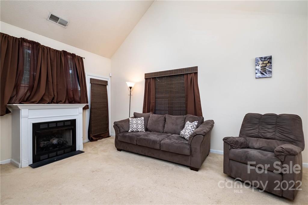 16865 Timber Crossing Road Charlotte, NC 28213 - Photo 11 of 36 a living room with furniture and a fireplace
