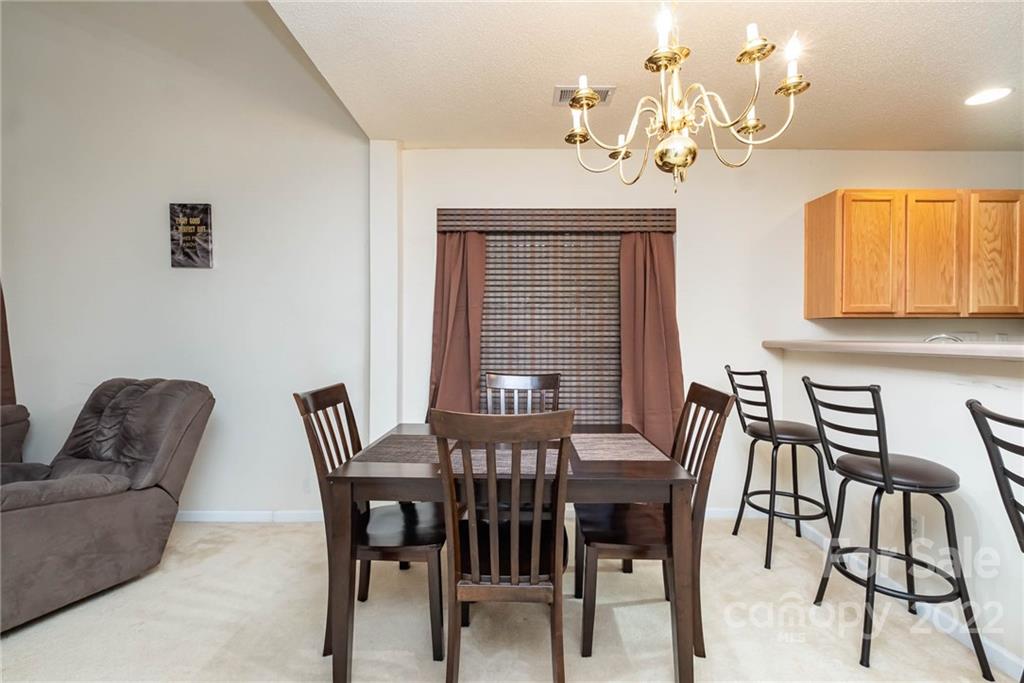 16865 Timber Crossing Road Charlotte, NC 28213 - Photo 14 of 36 a view of a dining room with furniture and a chandelier