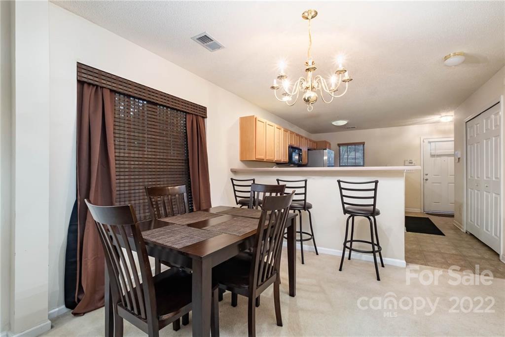 16865 Timber Crossing Road Charlotte, NC 28213 - Photo 15 of 36 a view of a dining room with furniture and a chandelier