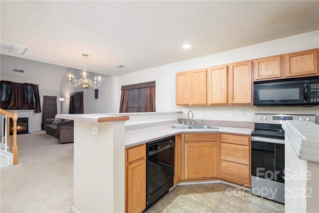 16865 Timber Crossing Road Charlotte, NC 28213 - Photo 19 of 36 a kitchen with a sink stove and microwave