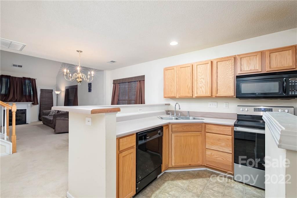 16865 Timber Crossing Road Charlotte, NC 28213 - Photo 20 of 36 a kitchen with a sink stove and microwave