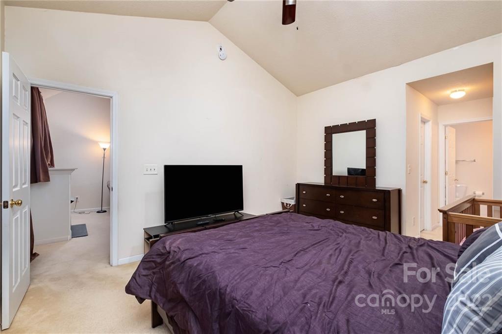 16865 Timber Crossing Road Charlotte, NC 28213 - Photo 26 of 36 a bedroom with a bed and a flat screen tv