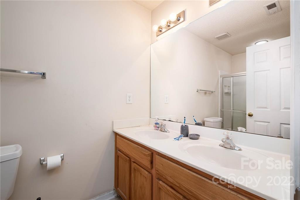16865 Timber Crossing Road Charlotte, NC 28213 - Photo 27 of 36 a bathroom with a sink and a mirror