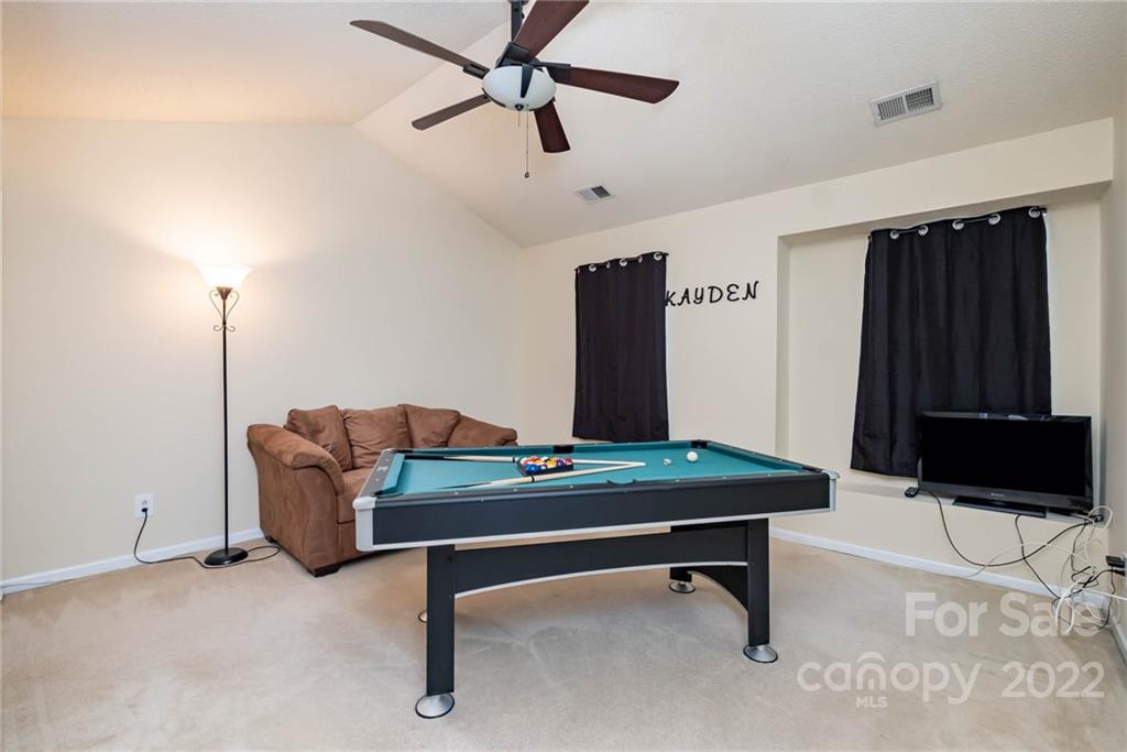 16865 Timber Crossing Road Charlotte, NC 28213 - Photo 31 of 36 a living room with furniture pool table and a flat screen tv