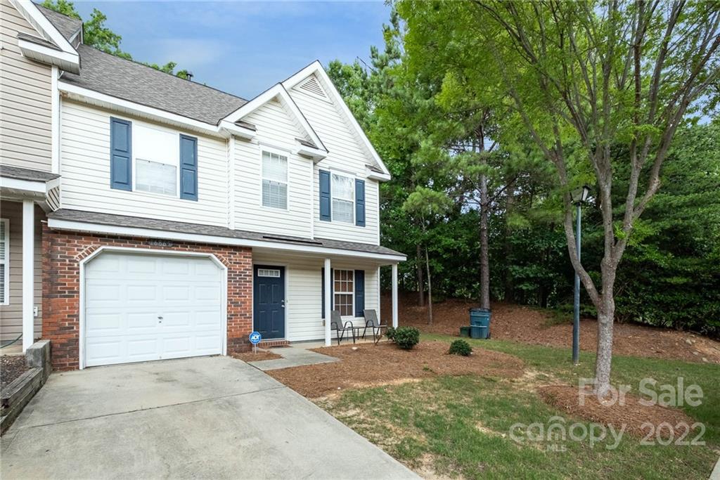16865 Timber Crossing Road Charlotte, NC 28213 - Photo 5 of 36 a view of a white house with a large windows and a large tree
