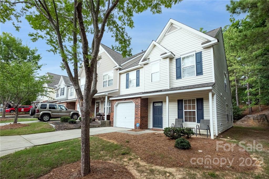 16865 Timber Crossing Road Charlotte, NC 28213 - Photo 6 of 36 a front view of a house with a yard and outdoor seating