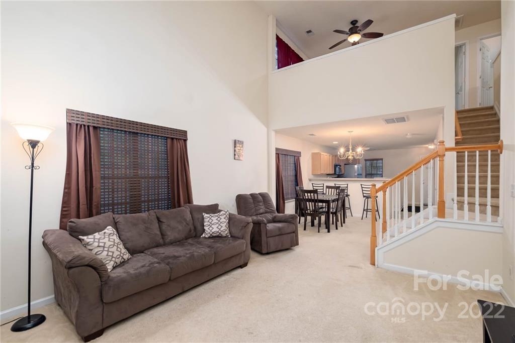 16865 Timber Crossing Road Charlotte, NC 28213 - Photo 8 of 36 a living room with furniture and a ceiling fan