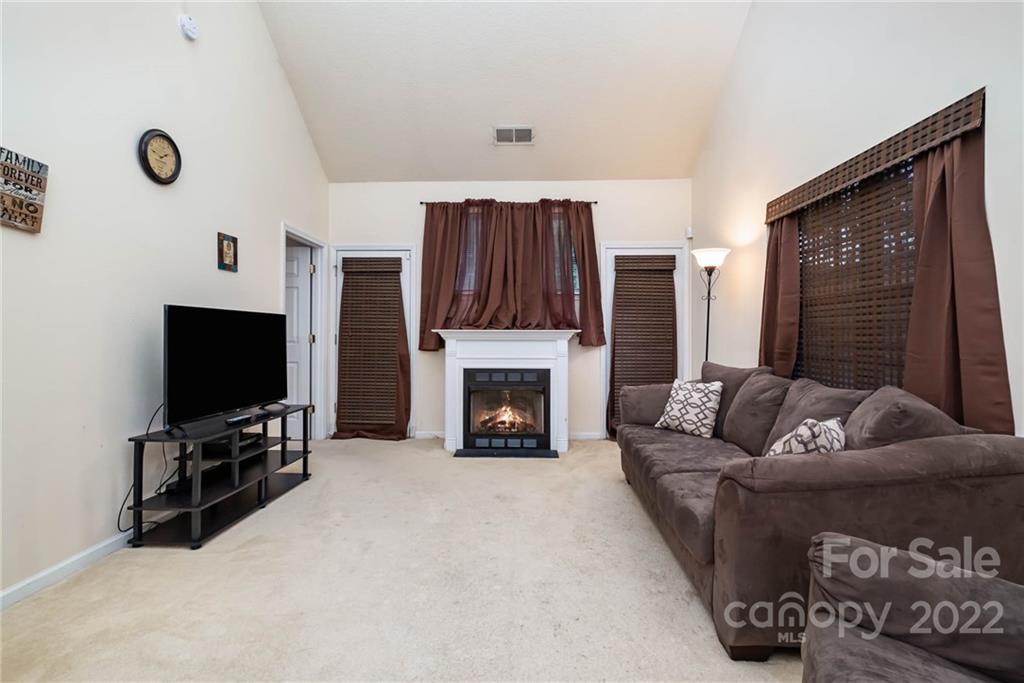 16865 Timber Crossing Road Charlotte, NC 28213 - Photo 9 of 36 a living room with furniture and a flat screen tv