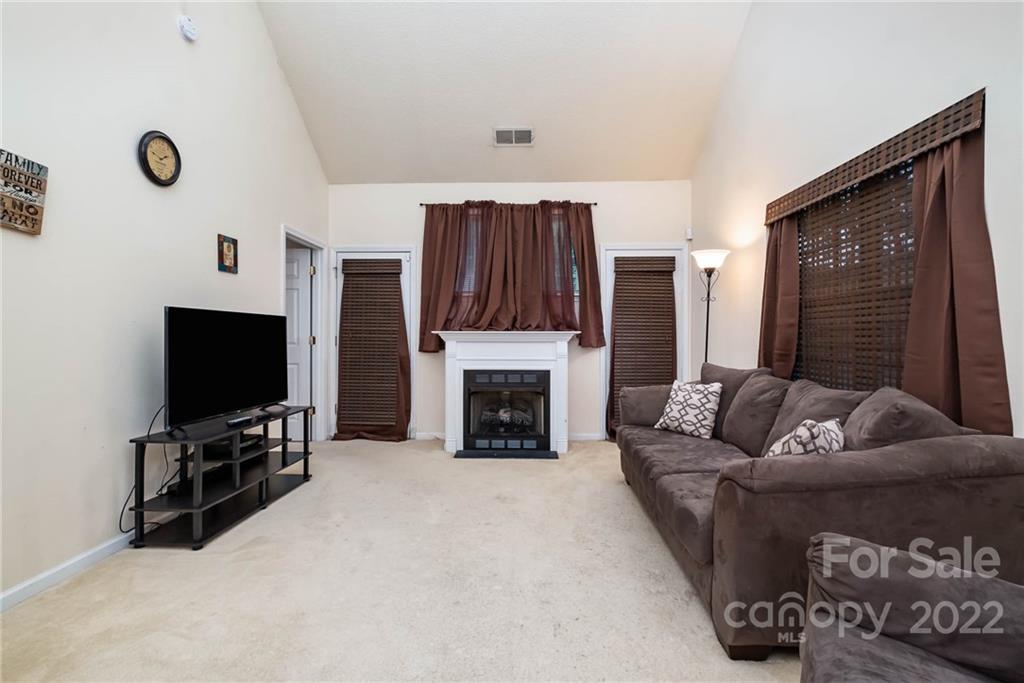 16865 Timber Crossing Road Charlotte, NC 28213 - Photo 10 of 36 a living room with furniture and a flat screen tv