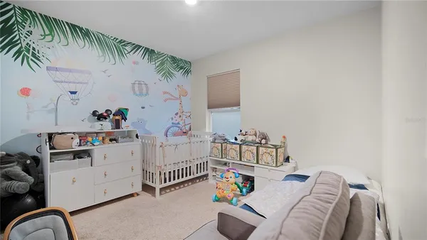 a bedroom with furniture and baby crib