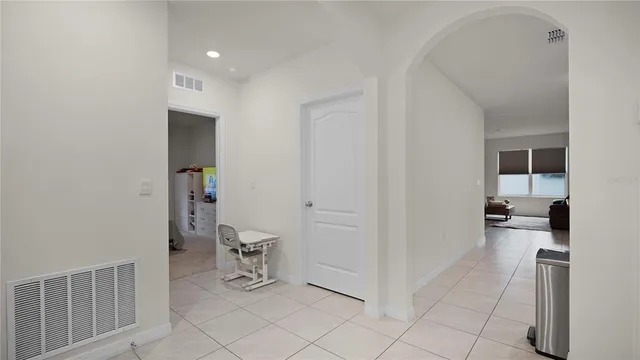 a room with furniture and a view of kitchen