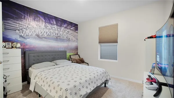 a bedroom with a bed and a mirror