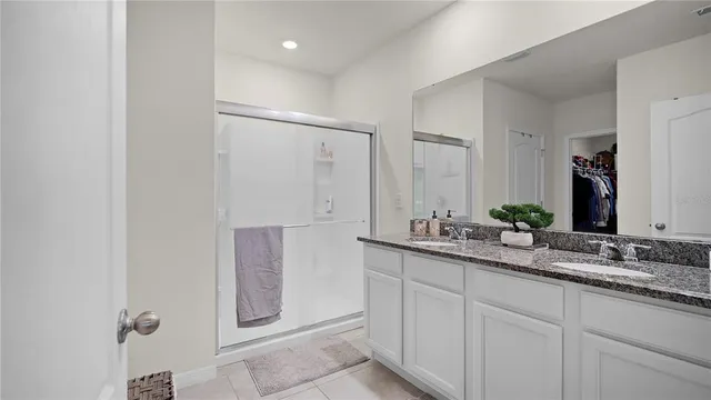 a view of bathroom with tub mirror and window