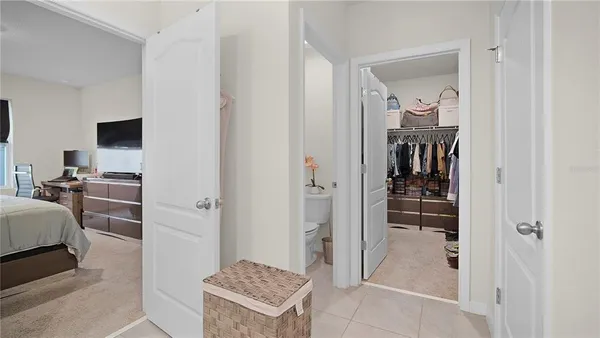 a view of walk in closet with clothes and shoes