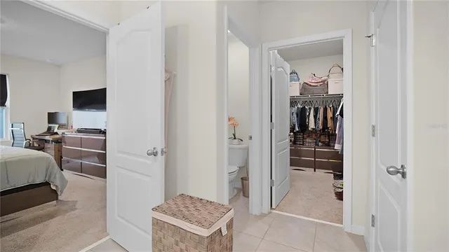 a view of walk in closet with clothes and shoes