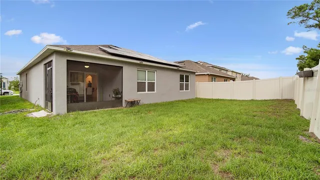 a view of a house with a backyard
