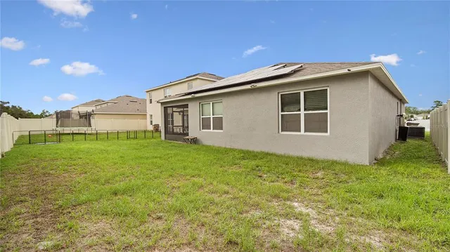 a view of a porch with furniture and a yard
