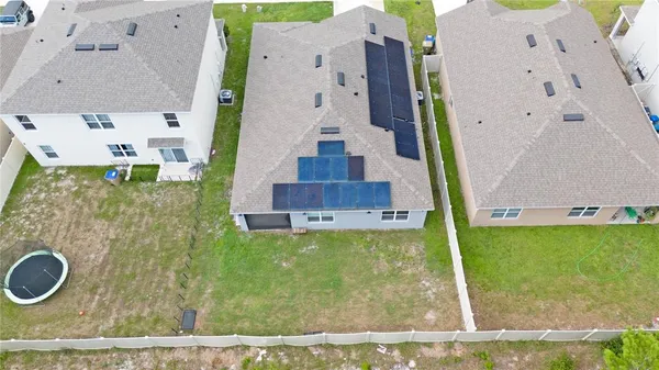 an aerial view of residential houses with outdoor space and swimming pool