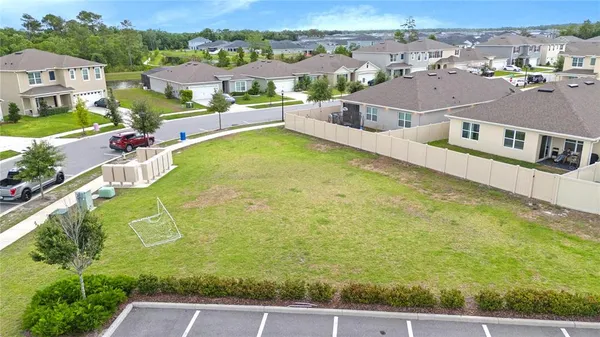 an aerial view of residential houses with yard