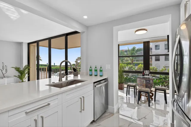a kitchen with a sink and large window