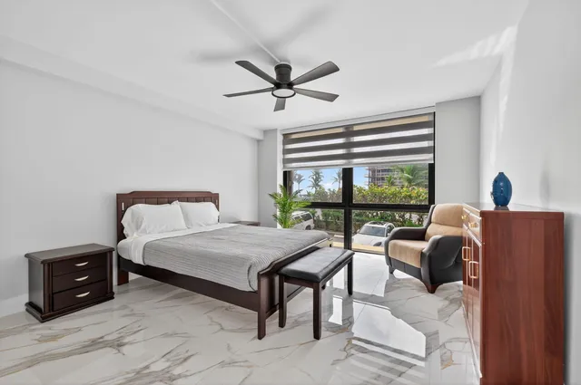 a bedroom with a bed and a large window