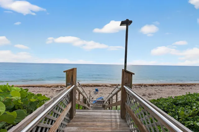 a view of a balcony with wooden floor and ocean view