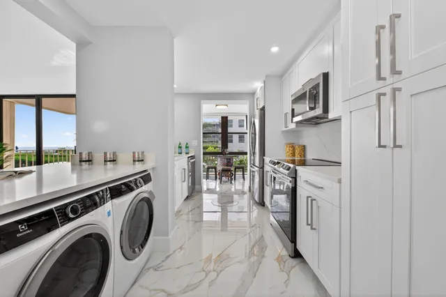 a kitchen with stainless steel appliances granite countertop a refrigerator and a stove top oven