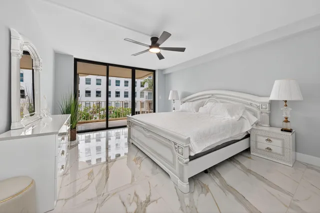 a white bed sitting in a bedroom next to a window