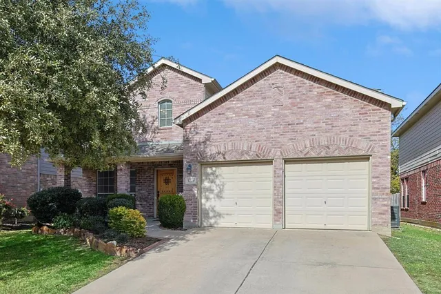 a view of a house with a yard and garage