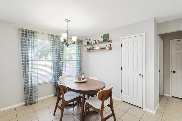 a view of a dining room with furniture and chandelier