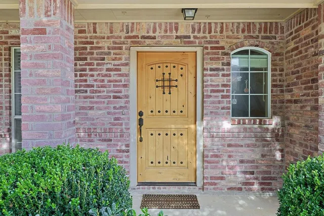 a front view of a building with a garden