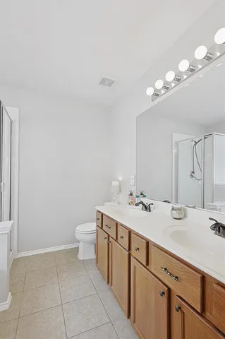 a bathroom with a sink a light fixture and a toilet
