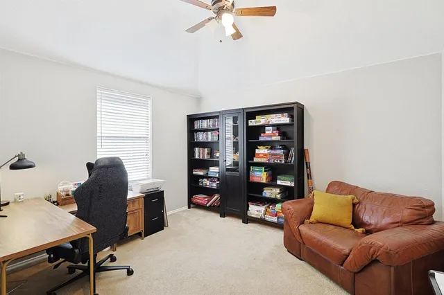 a work room with furniture and a bookshelf
