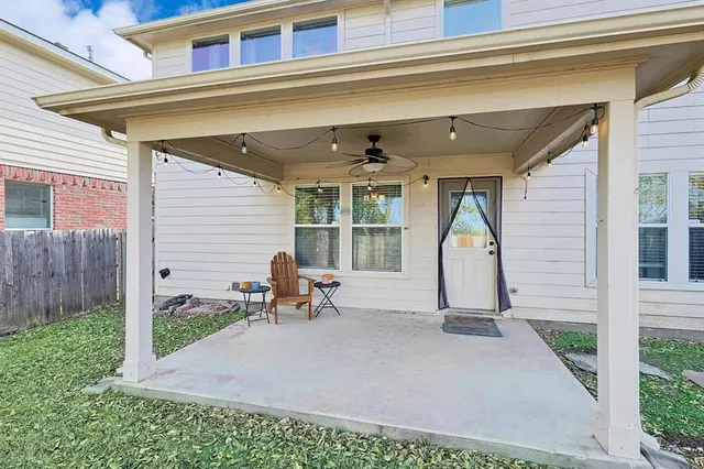 a view of a house with backyard and sitting area