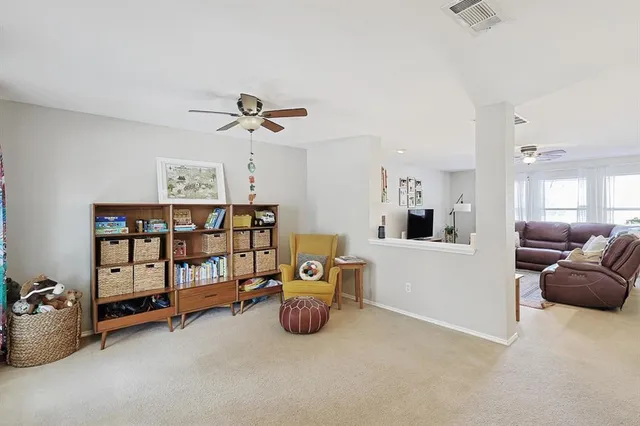 a view of a livingroom with furniture and staircase