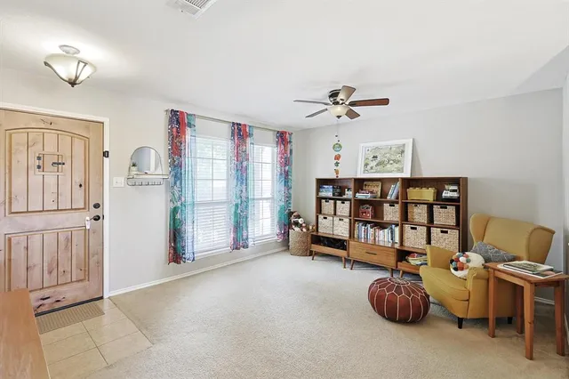 a view of a livingroom with furniture and a ceiling fan