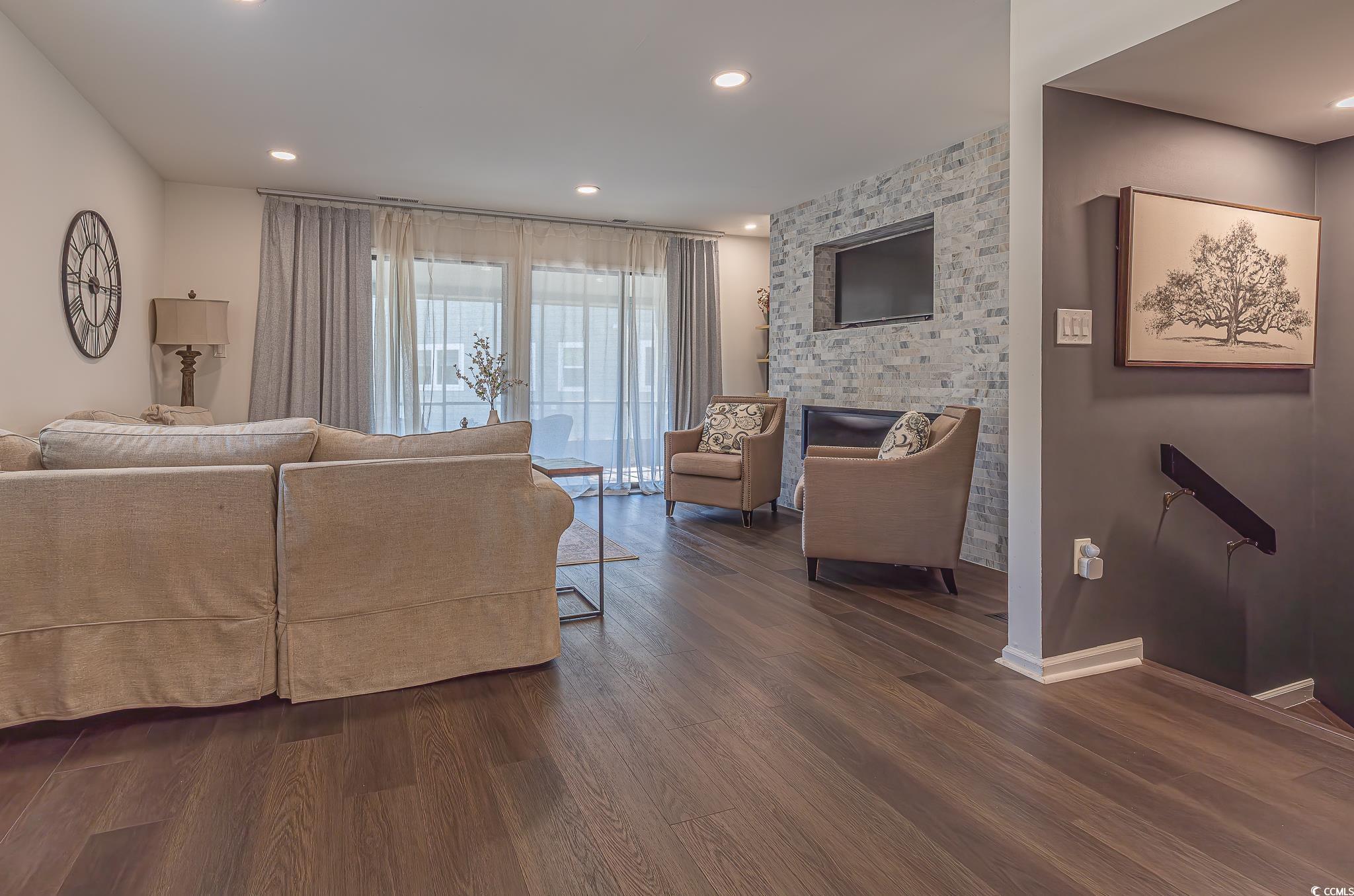 5137 Highway 17 Business, Unit 3A Murrells Inlet, SC 29576 - Photo 30 of 31 Living room featuring dark wood finished floors, recessed lighting, and an accent wall