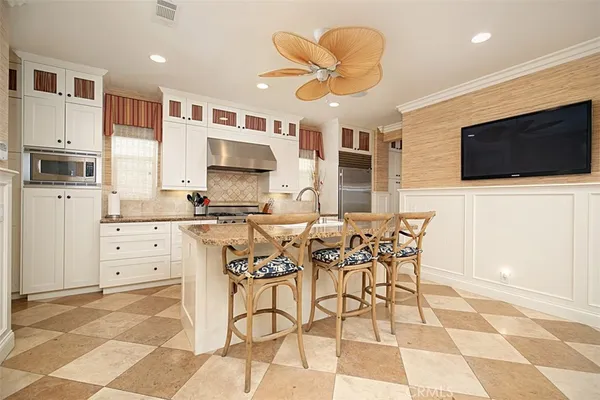 a kitchen with stainless steel appliances granite countertop a sink and a stove