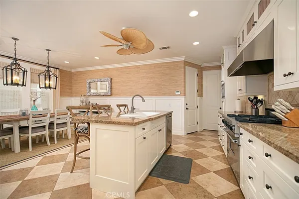 a kitchen with stainless steel appliances granite countertop a stove a sink and a refrigerator